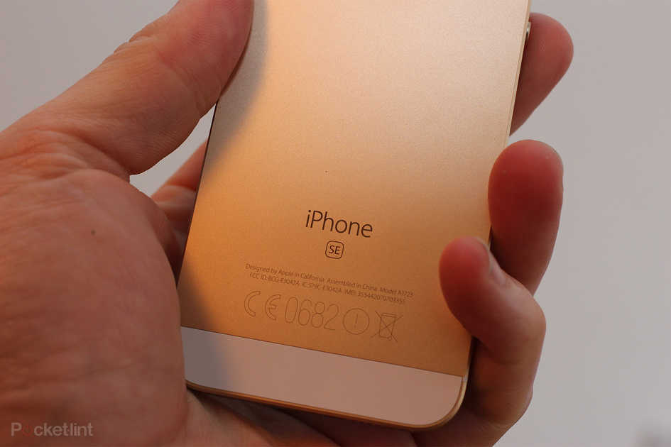 Iphone SE2 de color dorado sujetado con una mano